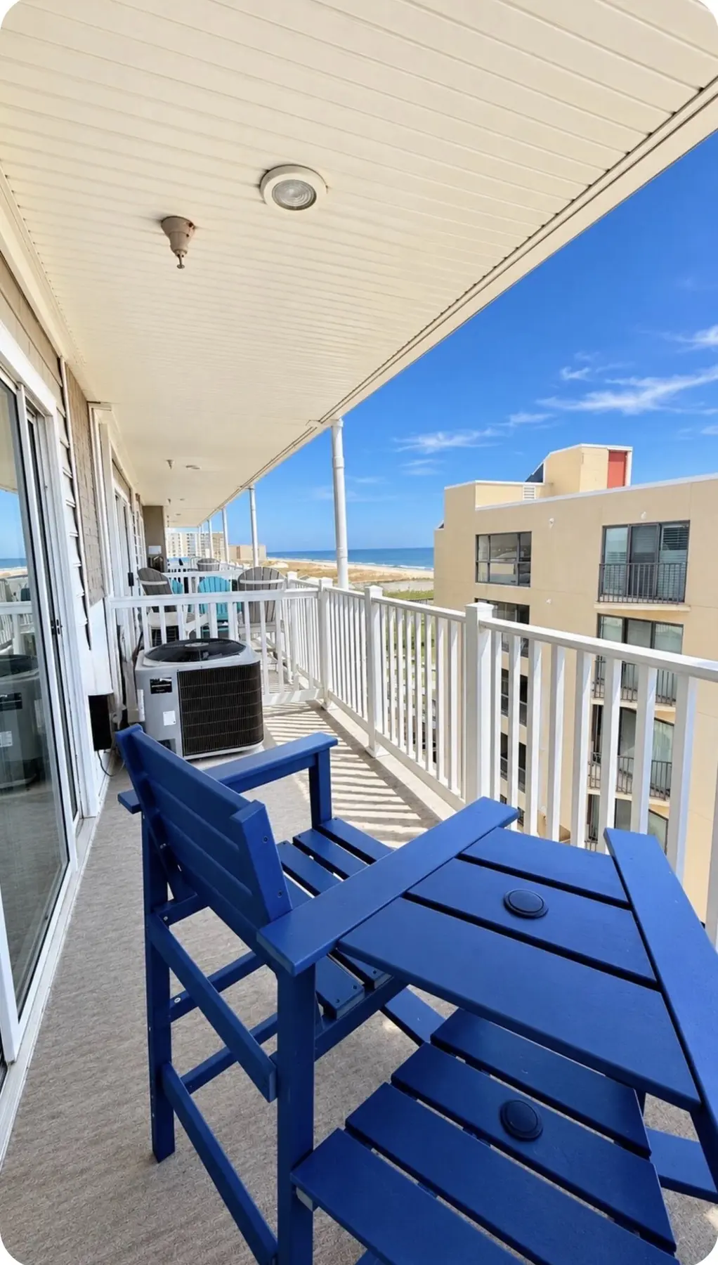 Private balcony with blue chairs and an ocean view
